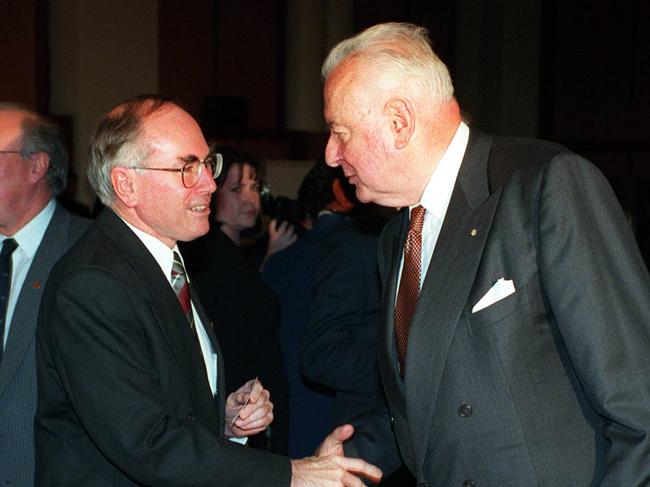 John Howar shakes hands with former PM Gough Whitlam in 1996.