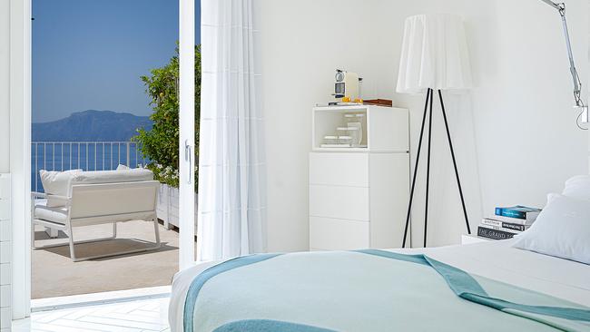 Rooms feature crisp white decor, accented with aquamarine cushions and throws.