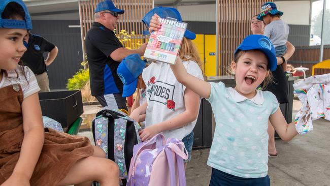 Lily, 7, is very excited as she opens donations made to the Clifton Creek Primary School. Picture: Jason Edwards