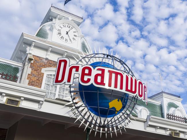 Gold Coast, Australia - December 02, 2014: The Facade of Dreamworld Gold Coast entrance building, Australia National flag flying against the beautiful clouds and blue sky.
