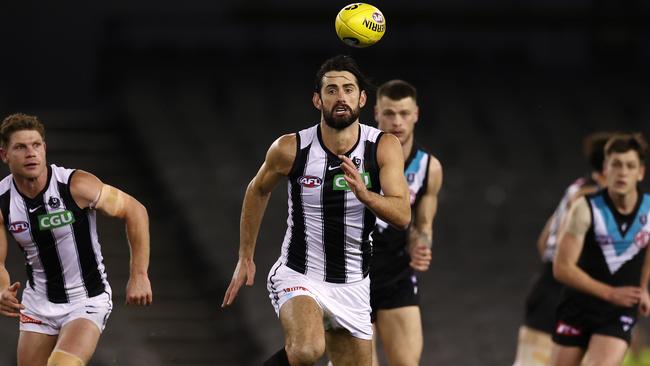 Brodie Grundy charges after the ball against Port Adelaide.