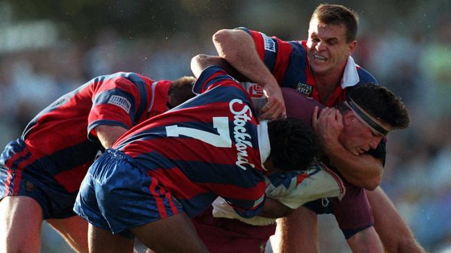 Paul Harragon tackles Mark Carroll in a game from 1997.