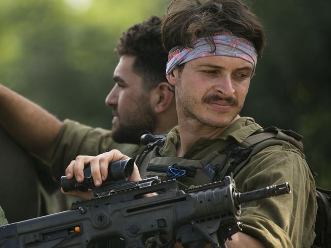 Soldiers drive an armour personnel carrier near the Israeli border with Lebanon. Picture: Getty Images