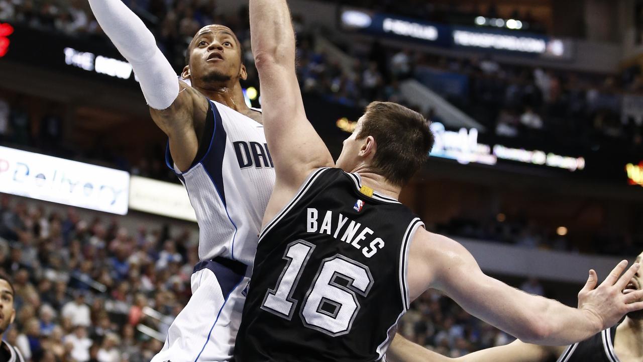 Dallas Mavericks guard Monta Ellis (11) shoots over San Antonio Spurs forward Aron Baynes (16) during the first half of an NBA basketball game, Saturday, Dec. 20, 2014, in Dallas. (AP Photo/Jim Cowsert)