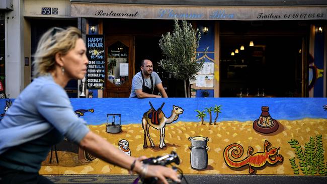 A man waits for business at a restaurant in Paris. Picture: AFP