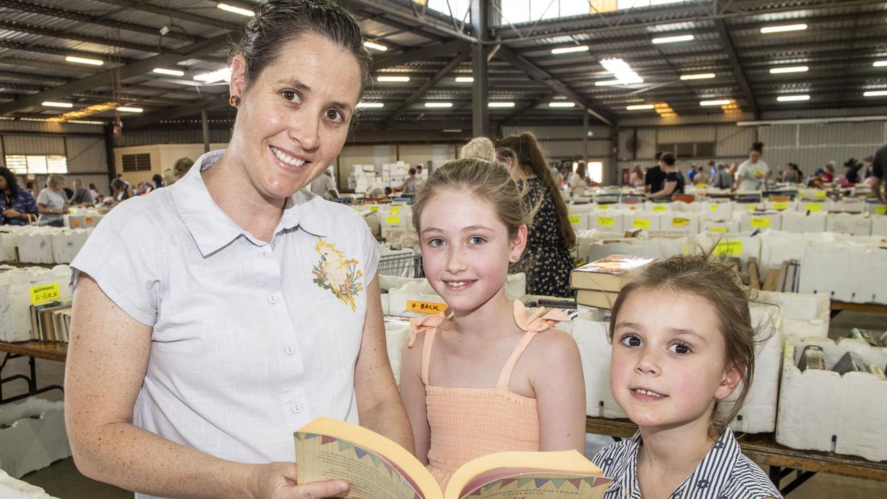 Melanie Dillmann and daughters Heidi, 9, and Eliza, 6, travelled from Southbrook to look through the thousands of books on offer at Lifeline BookFest. The Chronicle Lifeline BookFest at Toowoomba Showgrounds. Saturday, March 4, 2023. Picture: Nev Madsen.