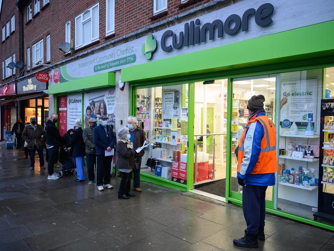 People queue for their Covid-19 vaccination appointments outside the Cullimore independent community chemist in Edgware. Picture: Getty Images