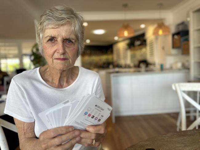 Journalist Ann Wason Moore's mother Susan Wason with the stack of gift cards she was forced to buy for a fraudster. Picture: Ann Wason Moore.