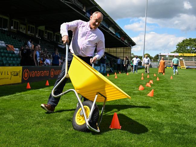 Leader of the Liberal Democrats Ed Davey races wheelbarrows at Yeovil Town Football Club on June 17. Davey has been criticised for his use of stunts during the campaign but polls show his party could do well on lection day. Picture: Finnbarr Webster/Getty Images