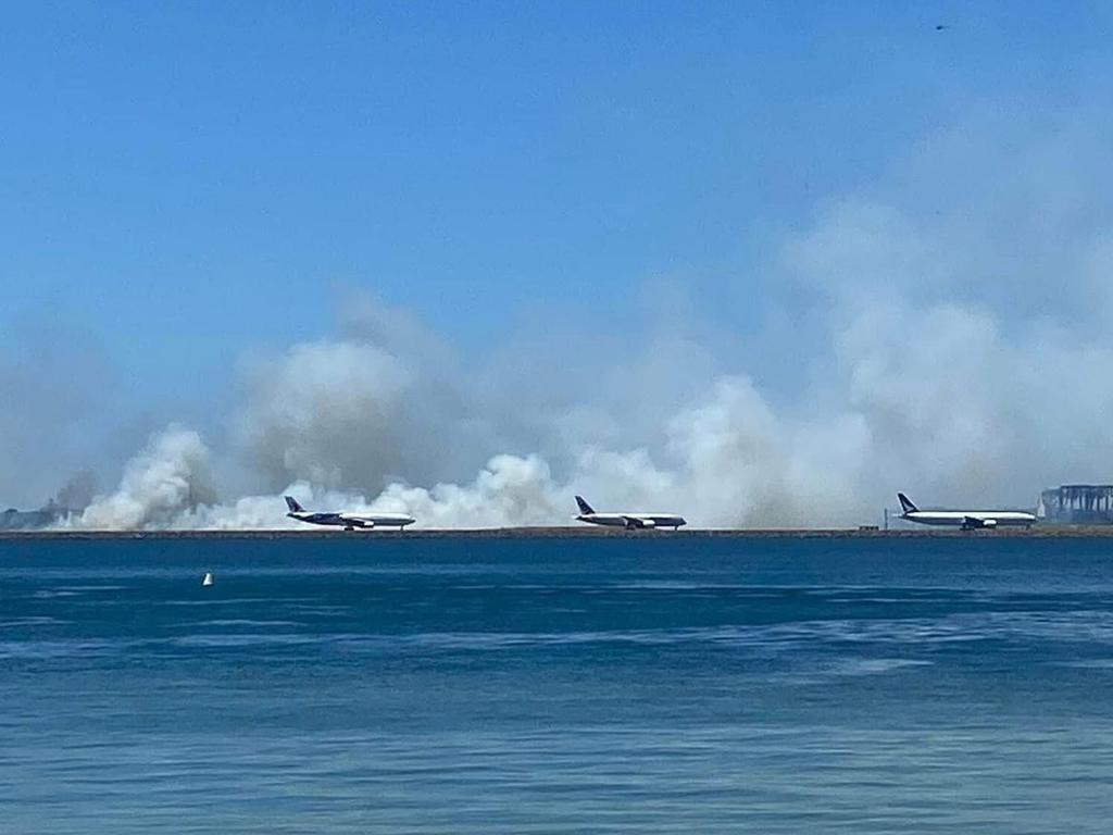 A﻿ grass fire has broken out at Sydney Airport, reportedly after a malfunction with an aircraft's engine on takeoff. Picture: 9News