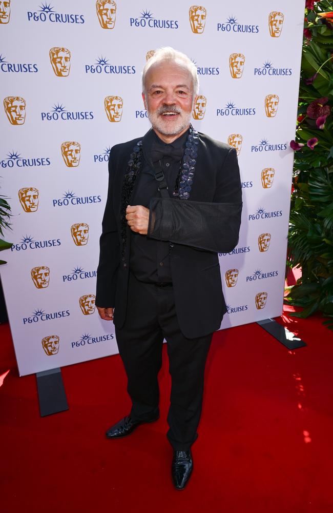 TV host Graham Norton accessorised his all-black suit with an arm sling. It’s unclear how Norton sustained the mystery injury. Picture: Eamonn M. McCormack/Getty Images for P & O Cruises