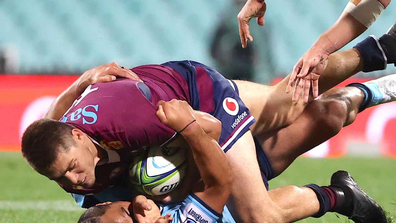 Karmichael Hunt of NSW tackles James O’Connor from the Reds during the Super Rugby match at the SCG won 45-12 by NSW. Picture: DAVID GRAY / AFP