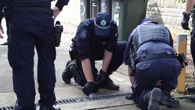 Police at the Auburn crime scene on Tuesday. Picture: John Grainger