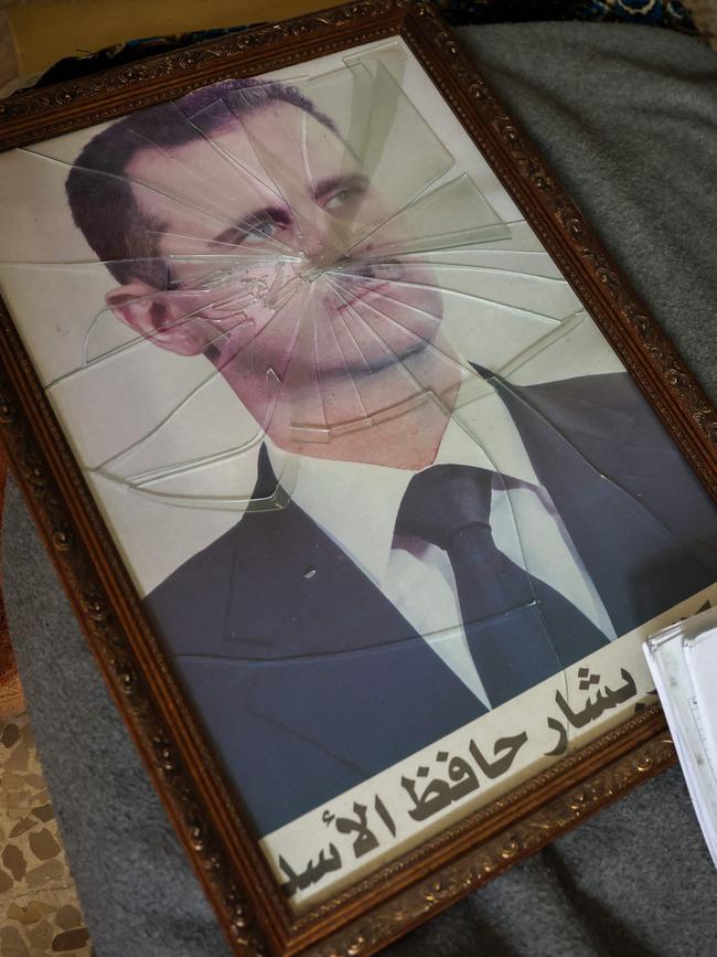 A portrait of Syrian President Bashar al-Assad is pictured with its frame broken, in a Syrian regime's Political Security Branch facility on the outskirts of the central city of Hama. Picture: Omar Haj Kadour/AFP