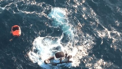 A police image showing the rescue of a missing fisherman off the coast of Cowley Beach on Sunday.