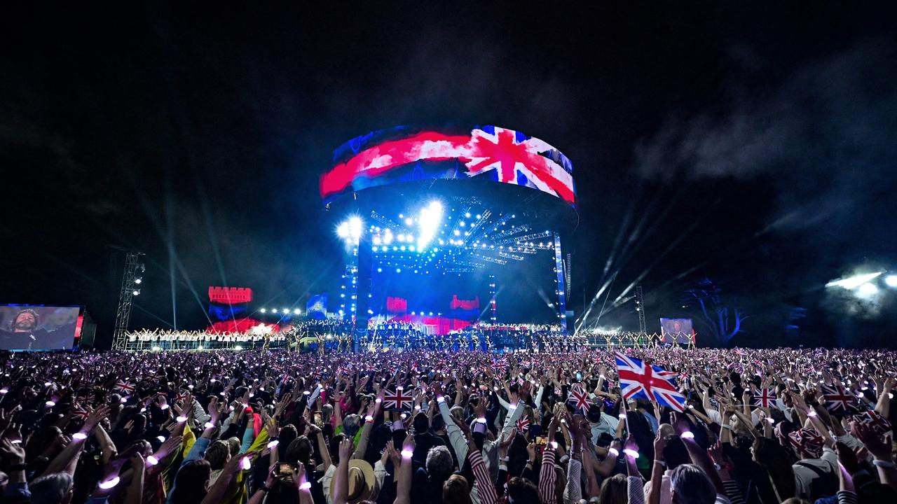 Crowds watch the acts on stage inside the grounds of Windsor Castle during the Coronation concert. Picture: AFP