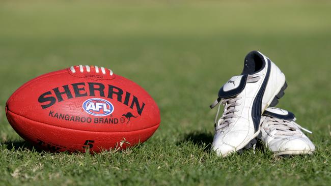 Generic AFL Sherrin football and football boots. sport /