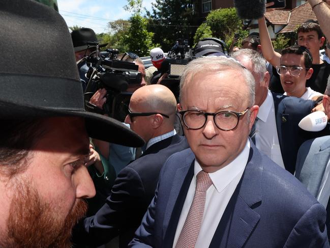 Prime Minister Anthony Albanese visits the fire damaged Adass Israel Synagogue in Ripponlea. The PM is looked concerned at the crowd crush while protected by his security team leaving from a side door of the Synagogue still wearing the Kippah after a meeting with community leaders.                  Picture: David Caird