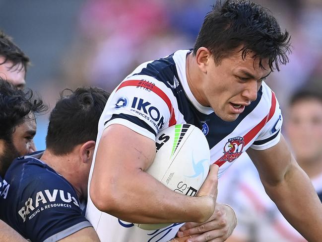 TOWNSVILLE, AUSTRALIA - JULY 17:  Joseph Manu of the Roosters is tackled during the round 18 NRL match between the North Queensland Cowboys and the Sydney Roosters at QCB Stadium, on July 17, 2021, in Townsville, Australia. (Photo by Ian Hitchcock/Getty Images)