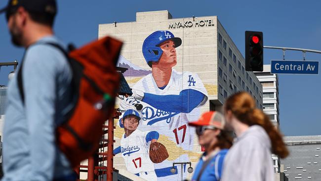 Pedestrians walk beneath a new mural depicting Los Angeles Dodgers star Shohei Ohtani, created by artist Robert Vargas on the Miyako Hotel in the neighborhood of Little Tokyo, Los Angeles. Picture: Mario Tama/Getty Images/AFP