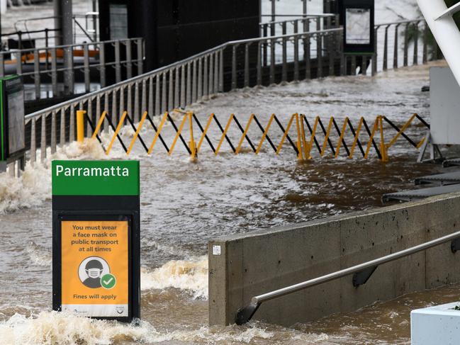 SYDNEY, AUSTRALIA - NewsWire Photos MARCH, 20, 2021: The footpath is seen submerged by floodwater as the Parramatta River overflows at the Charles St weir and ferry wharf, at Parramatta in Sydney. More rain is forecast for the NSW coast and other parts of the state over the weekend, with flood warnings in place and the Premier advising residents to stay home. Picture: NCA NewsWire/Bianca De Marchi