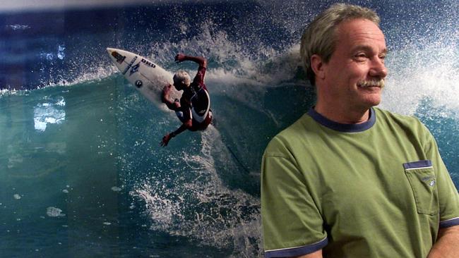 Rip Curl’s Brian Singer at his Torquay office standing in front of poster featuring surfer Mick Fanning in 2002. Picture: Colin Murty.