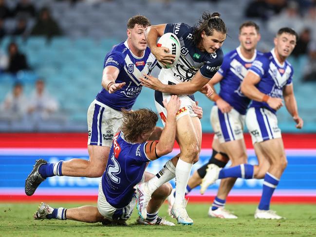 SYDNEY, AUSTRALIA - APRIL 02: Tom Chester of the Cowboys is tackled during the round five NRL match between Canterbury Bulldogs and North Queensland Cowboys at Accor Stadium on April 02, 2023 in Sydney, Australia. (Photo by Cameron Spencer/Getty Images)