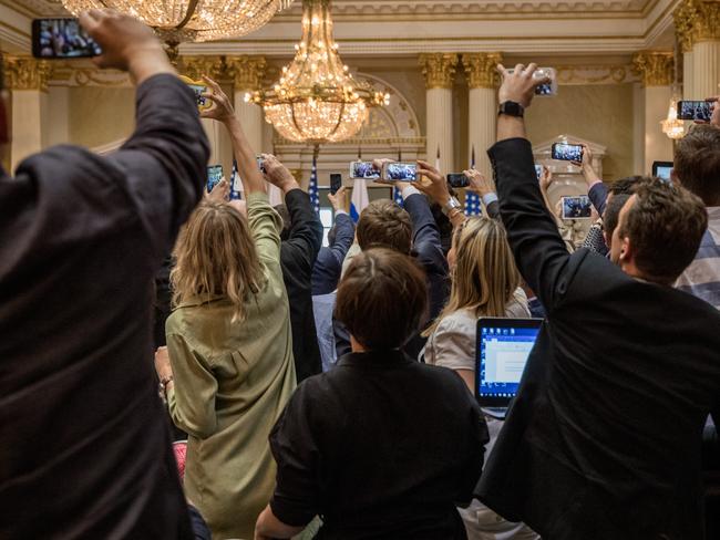 Members of the US and Russian press film as the protester is removed. Picture: Chris McGrath/Getty Images.