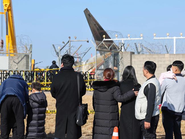 Mourners gather at the site where a Jeju Air Boeing 737-800 aircraft crashed and burst into flames at Muan International Airport. Picture: AFP