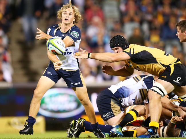 Joe Powell passes during the round three Super Rugby match between the Brumbies and the Force at GIO Stadium.