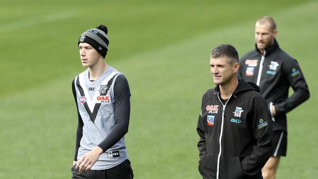 Todd Marshall all smiles as he returns to the side walking with assistant coaches Nathan Bassett and Scott Thompson. Picture Sarah Reed