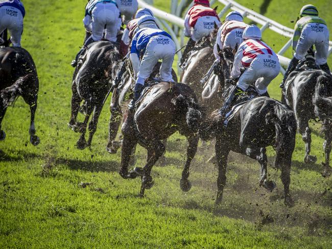 Sorry sight: excessive turf kickback occurs during one of the races at Eagle Farm on Saturday. Picture: AAP