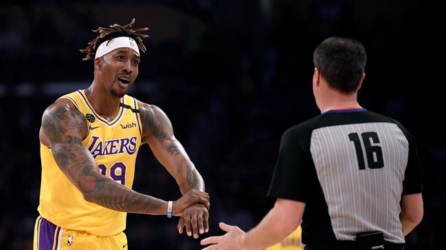 (FILES) In this file photo Dwight Howard #39 of the Los Angeles Lakers argues his foul call with referee David Guthrie #16 during the first quarter at Staples Center on February 21, 2020 in Los Angeles, California. - Los Angeles Lakers center Dwight Howard says he will play when the NBA season resumes in Orlando on July 30, 2020 despite concerns the restart might distract from his social activism. Howard announced his decision to join LeBron James and his other Laker teammates in a CNN appearance late Monday, citing his contract and his hunger to win an NBA crown at age 34. (Photo by Harry How / GETTY IMAGES NORTH AMERICA / AFP)