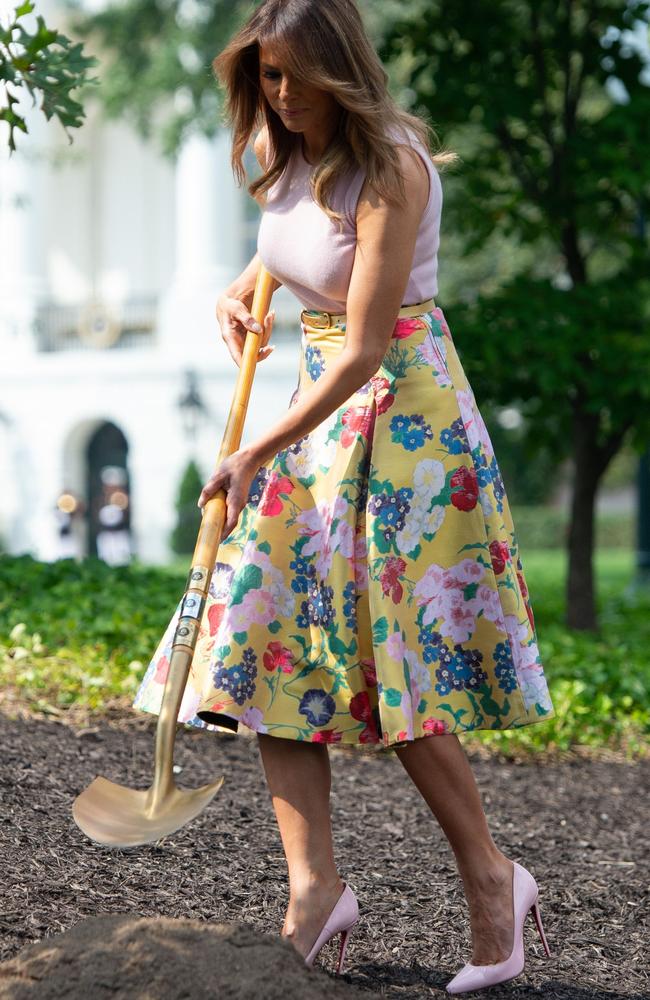 The First Lady puts her golden shovel to work. Picture: Saul Loeb/AFP