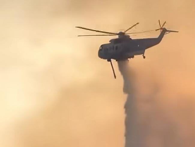 A helicopter drops water on a bushfire burning in the  Grampians. picture: Lexton CFA / Facebook