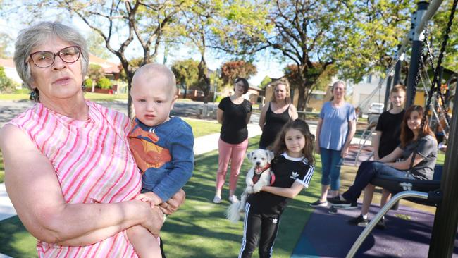 Kaye Fraser at Irving Street Reserve with her grandson Charlie Cox and residents who oppose a boarding house in the neighbourhood. Picture: Angelo Velardo