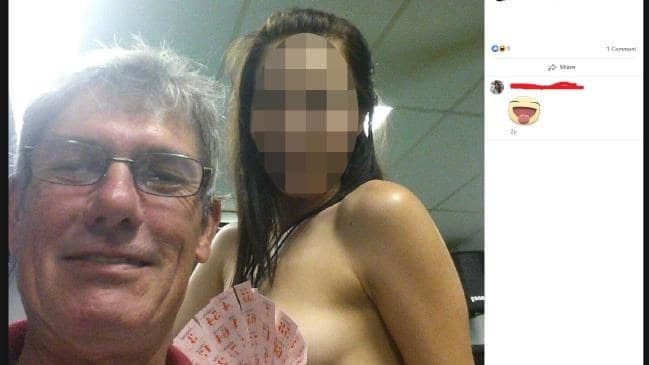 Mr Macdonald posing with a topless woman 