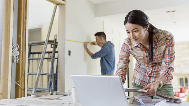 Young couple working on home renovations