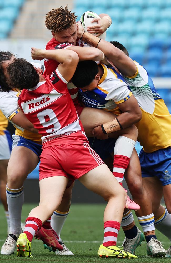 NRL National Schoolboys Cup final at CBUS Stadium between Palm Beach Currumbin and Patrician Blacktown Brothers. Palm Beach Currumbin's Jac Finigan driven back by Patrician Blacktown Brothers defence. .Picture Glenn Hampson