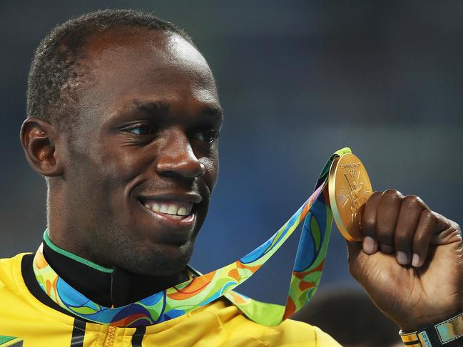 Usain Bolt of Jamaica with his Gold medal from the Men's 200m Final during the Athletics on Day 14 of the Rio 2016 Olympic Games. Picture. Phil Hillyard