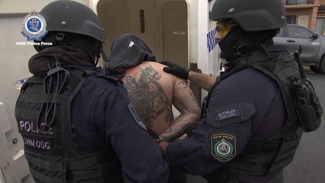 Alleged Rebels bikie Aleksander Mahone, 31, is arrested after allegations he choked and assaulted his partner. Picture: NSW Police Media