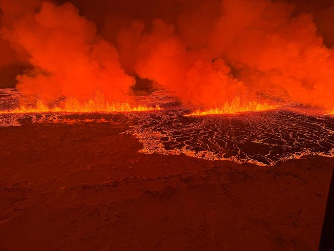 Smoke and lava from the volcano’s eruption, turning the sky orange. Picture: Icelandic Coast Guard/AFP