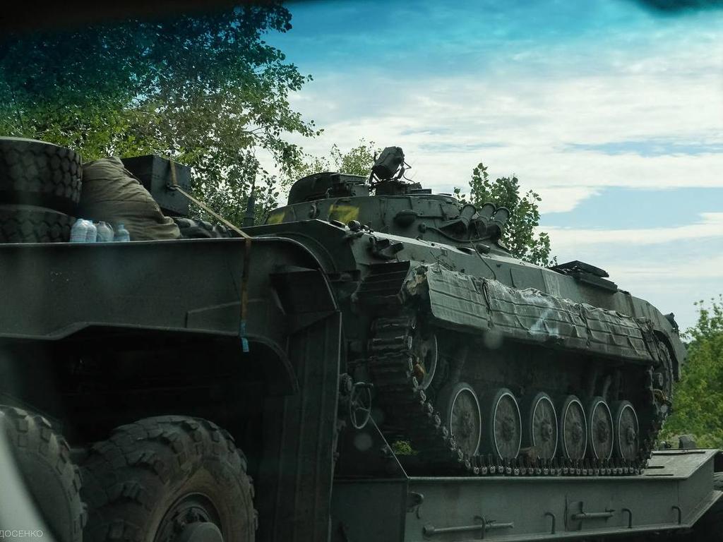 An abandoned Russian military vehicle is loaded on a trailer during the Ukarinian Army counteroffensive in Kharkiv region. Picture: AFP