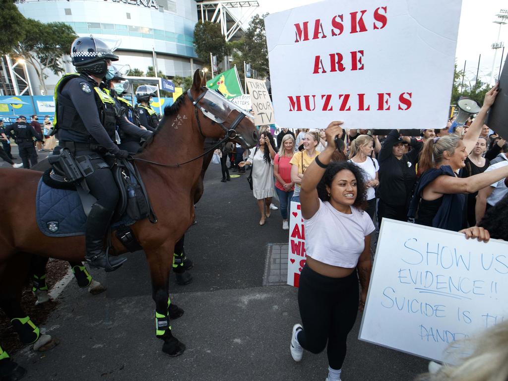 Anti-lockdown protesters march to the Australian Open at Melbourne Park on Friday evening. Picture: David Geraghty