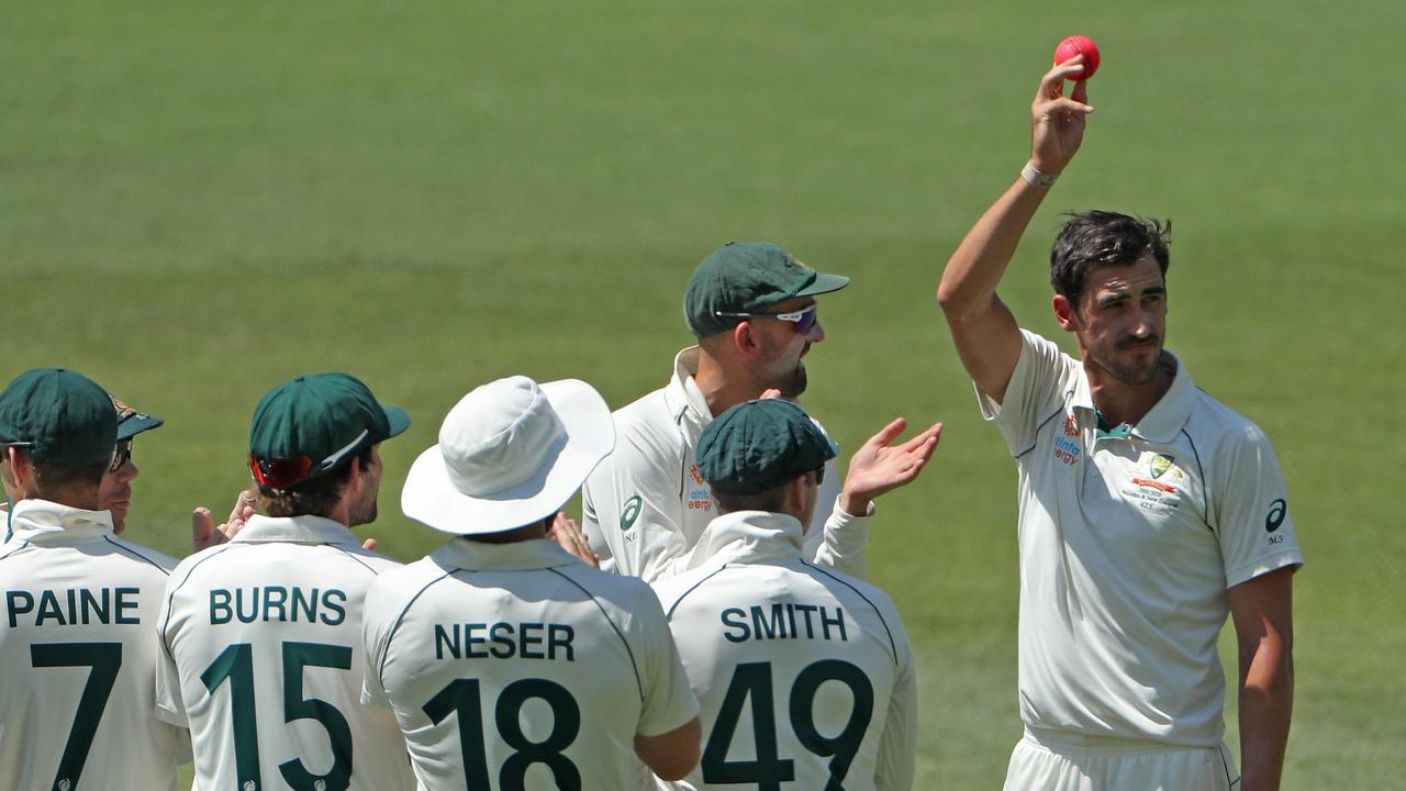 Mitchell Starc is clapped by his teammates after snaring his fifth scalp on day three.