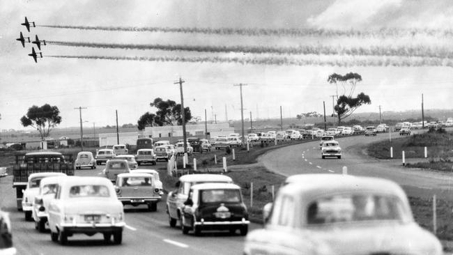 A huge airshow turnout in 1964 left traffic at a standstill and many climbing onto the roofs of their cars to watch on the Princes Highway.