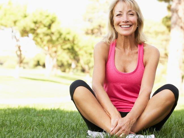 Senior Woman Resting After Exercising In Park Smiling To Camera, active and happy retiree generic