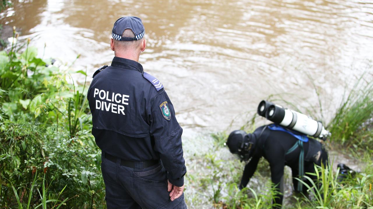 Police divers search a dam less than 500 metres from the dig site. Picture: NCA NewsWire / Peter Lorimer.