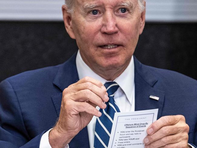 US President Joe Biden speaks from his notes with governors, labor leaders, and private companies launching the Federal-State Offshore Wind Implementation Partnership as he drops by a meeting at the White House in Washington, DC, on June 23, 2022. (Photo by Jim WATSON / AFP)