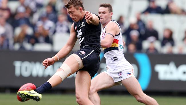 Patrick Cripps of the Blues kicks away from Adelaide's Brad Crouch. Picture: Michael Klein